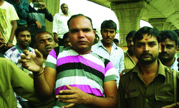 Bus conductor Madan and other co-passengers catch hold of M.R. Sahoo (in a striped T-shirt), a CRPF constable from Odisha and working as a security guard at KIA, before handing him over to the police for misbehaving with women on a bus on Friday ( Bus conductor Madan and other co-passengers catch hold of M.R. Sahoo (in a striped T-shirt), a CRPF constable from Odisha and working as a security guard at KIA, before handing him over to the police for misbehaving with women on a bus on Friday (